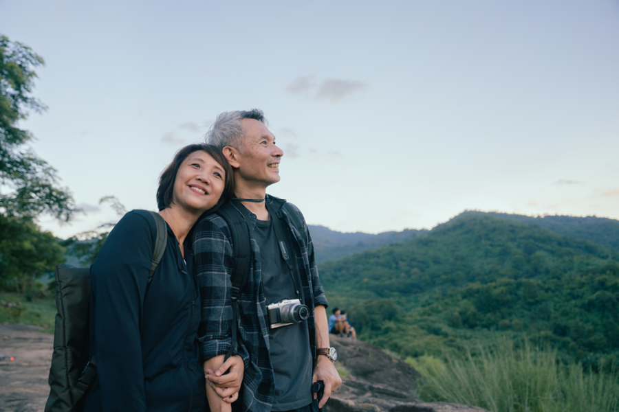 Couple smiling and enjoying an amazing view.