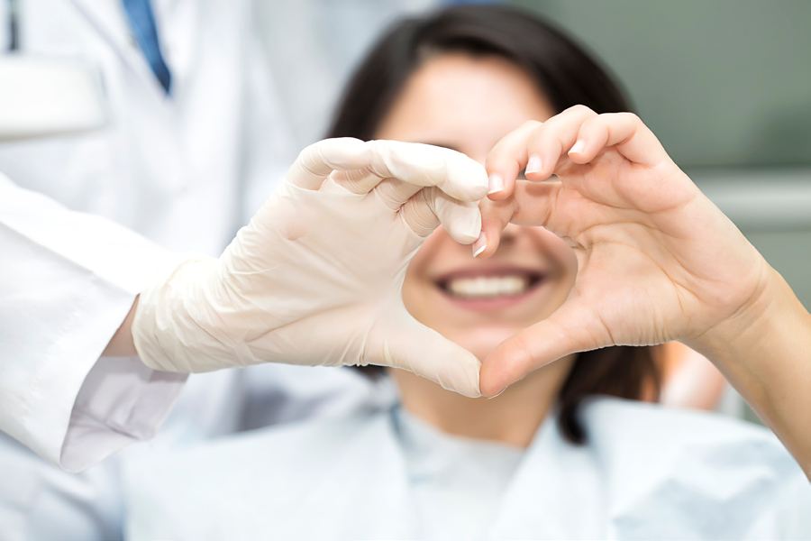 Person holding up a heart with their hands.