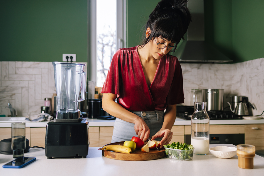 Person making a meal with glasses on.