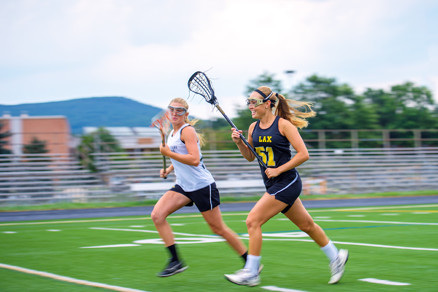 Girls playing lacrosse.