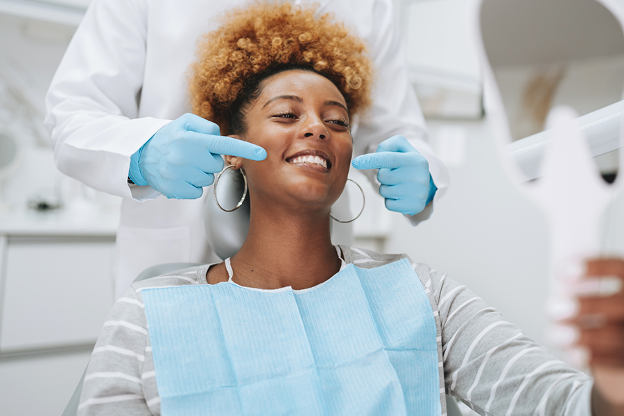 Person smiling in the dental chair.