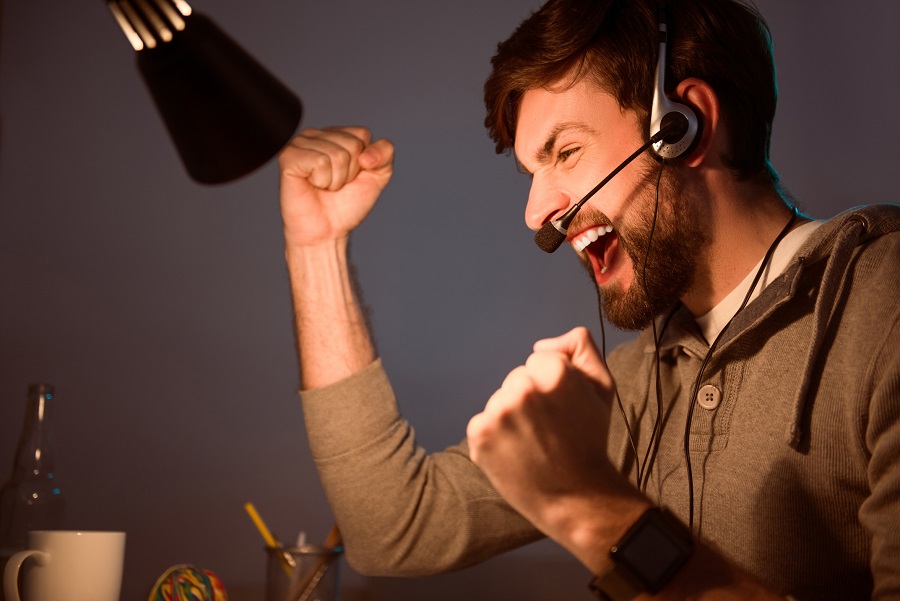 Man with a headset on, smiling 