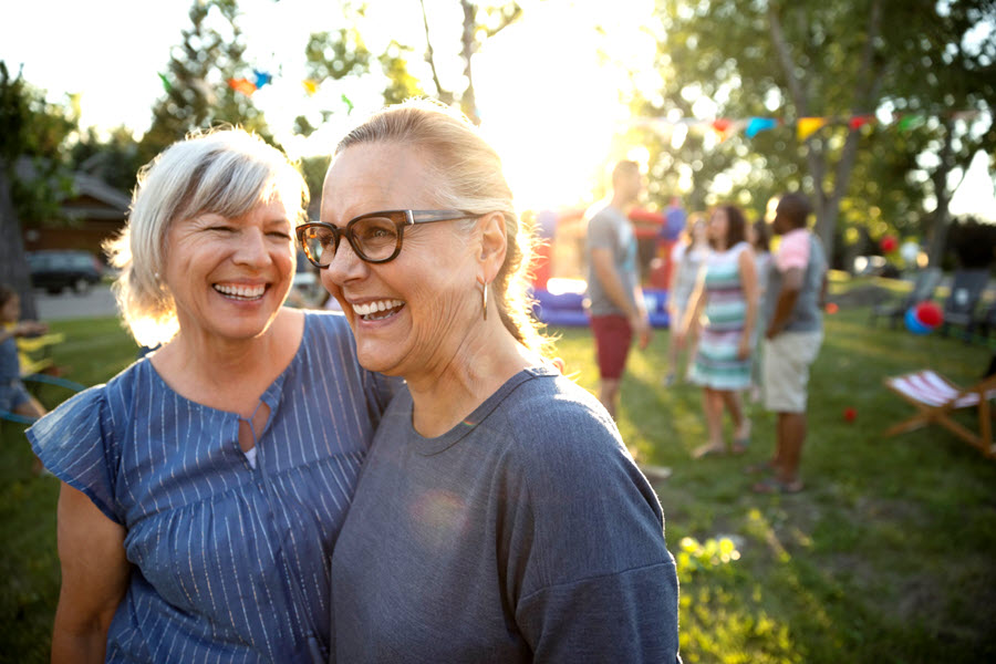 Two women smiling outside