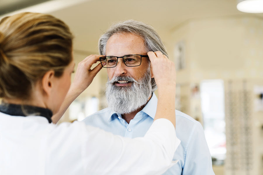 Man trying on glasses