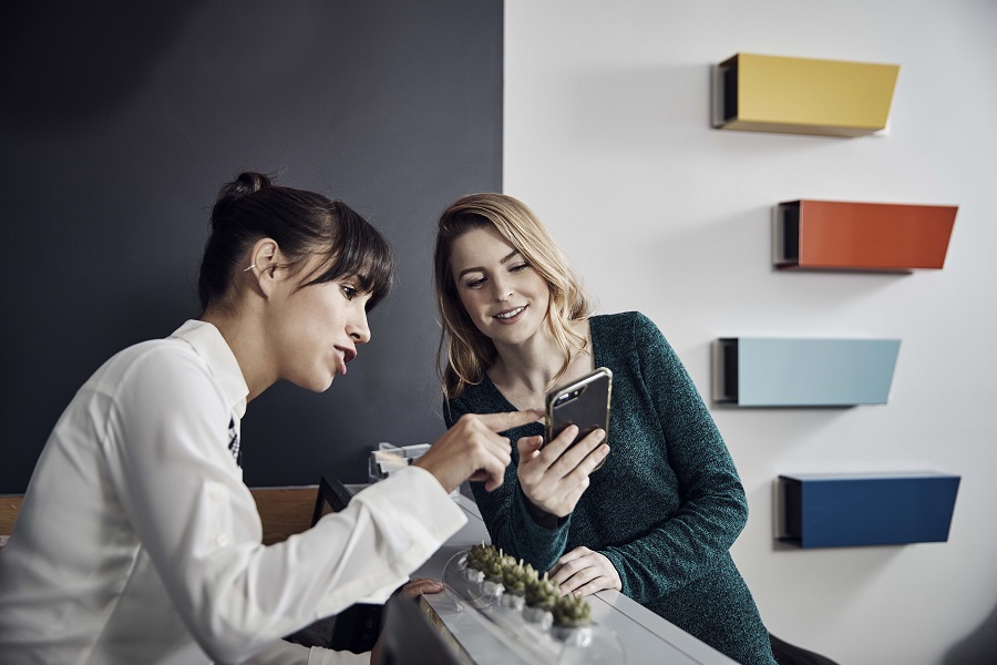 Dentist leaning over to show patient something