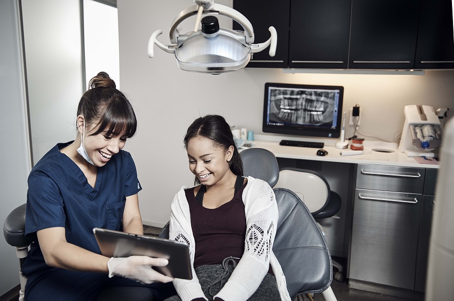 Dentist sitting down with patient