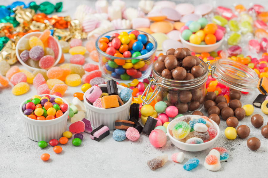 several jars of chocolate and bright colored candy