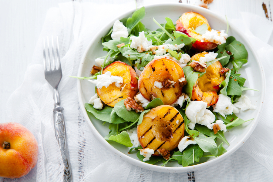bowl of grilled peaches, feta cheese and spinach