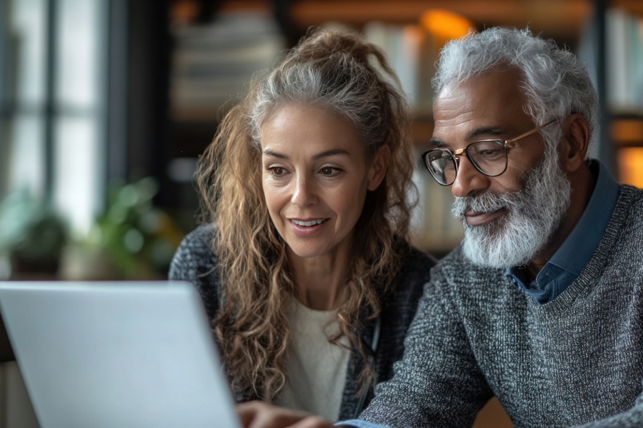 man and women reviewing information on a laptop