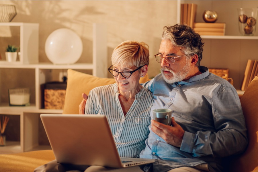 senior man and woman working on a laptop