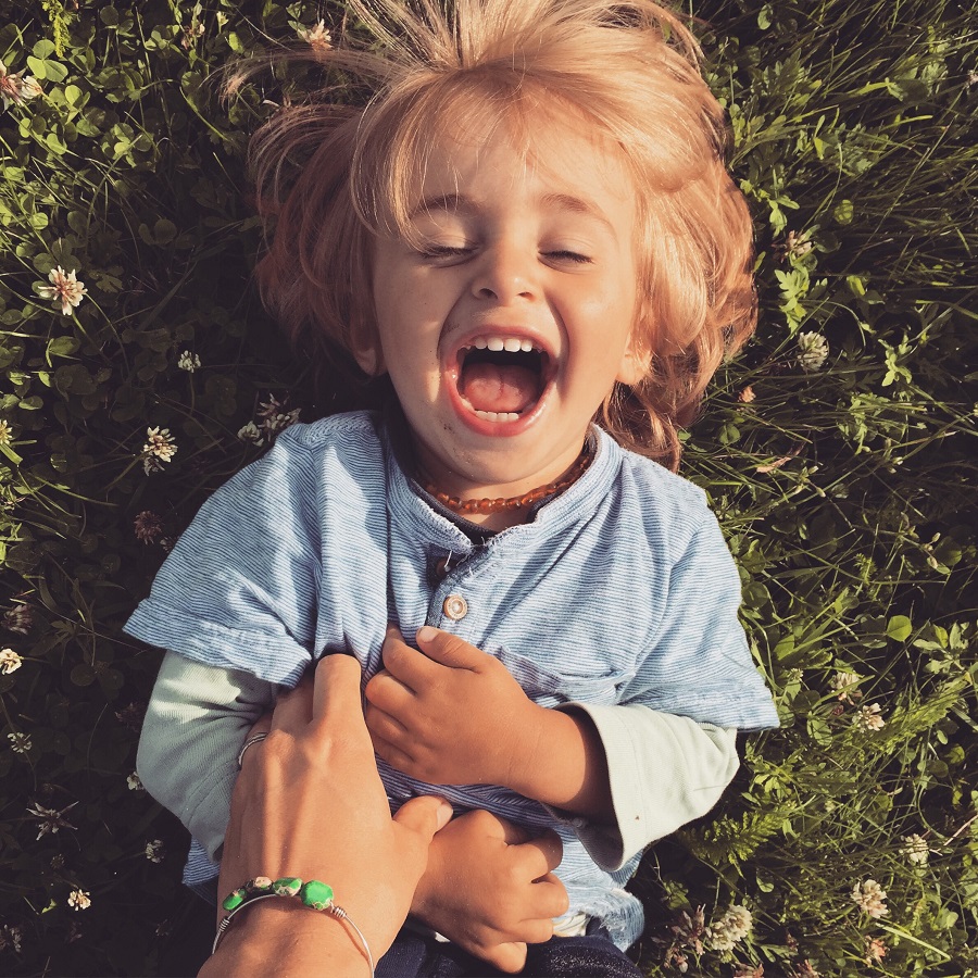 Little Boy laughing on the ground