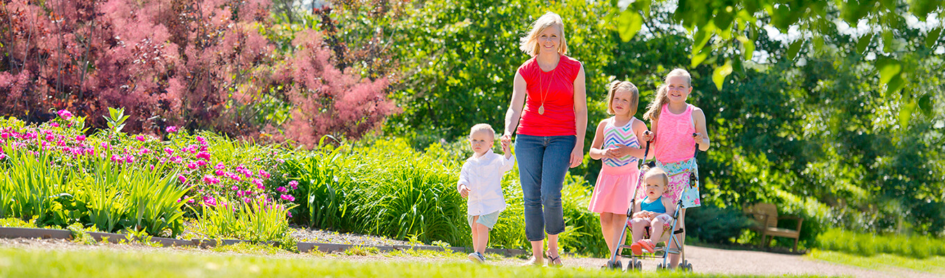 Child walking with parent in park