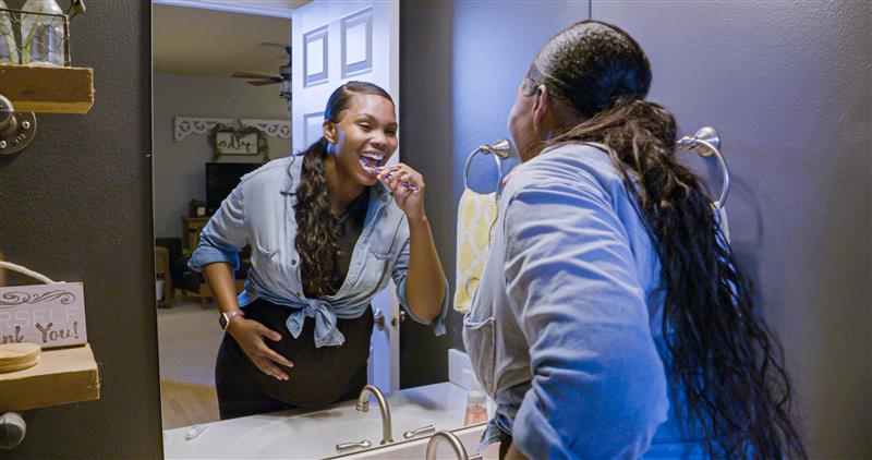 Pregnant woman brushing her teeth